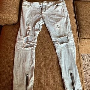 Ripped jeans with zippers on both sides of the legs